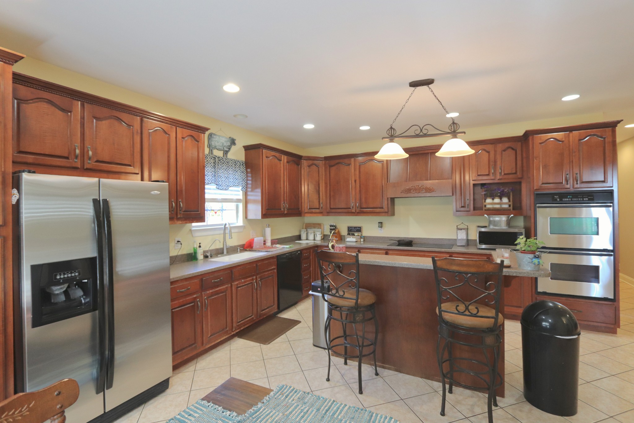 621 Hamilton Chambers Road Lebanon, TN 37087 - Photo 13 of 37 a kitchen with granite countertop a center island stainless steel appliances cabinets and a counter top space