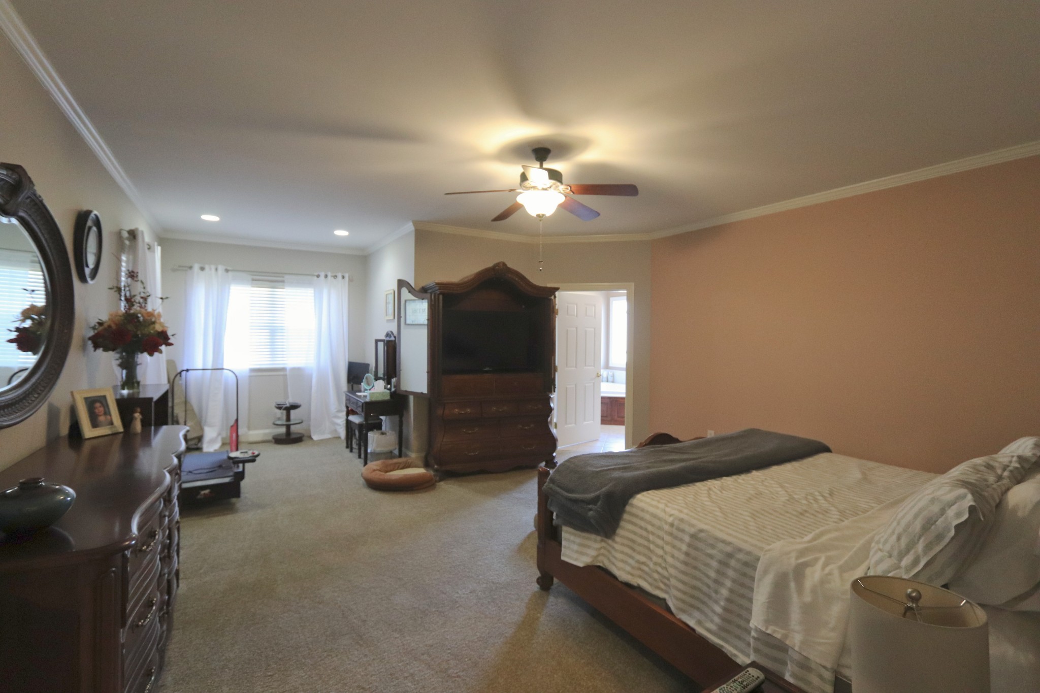 621 Hamilton Chambers Road Lebanon, TN 37087 - Photo 18 of 37 a bedroom with bed a flat tv screen and a chandelier