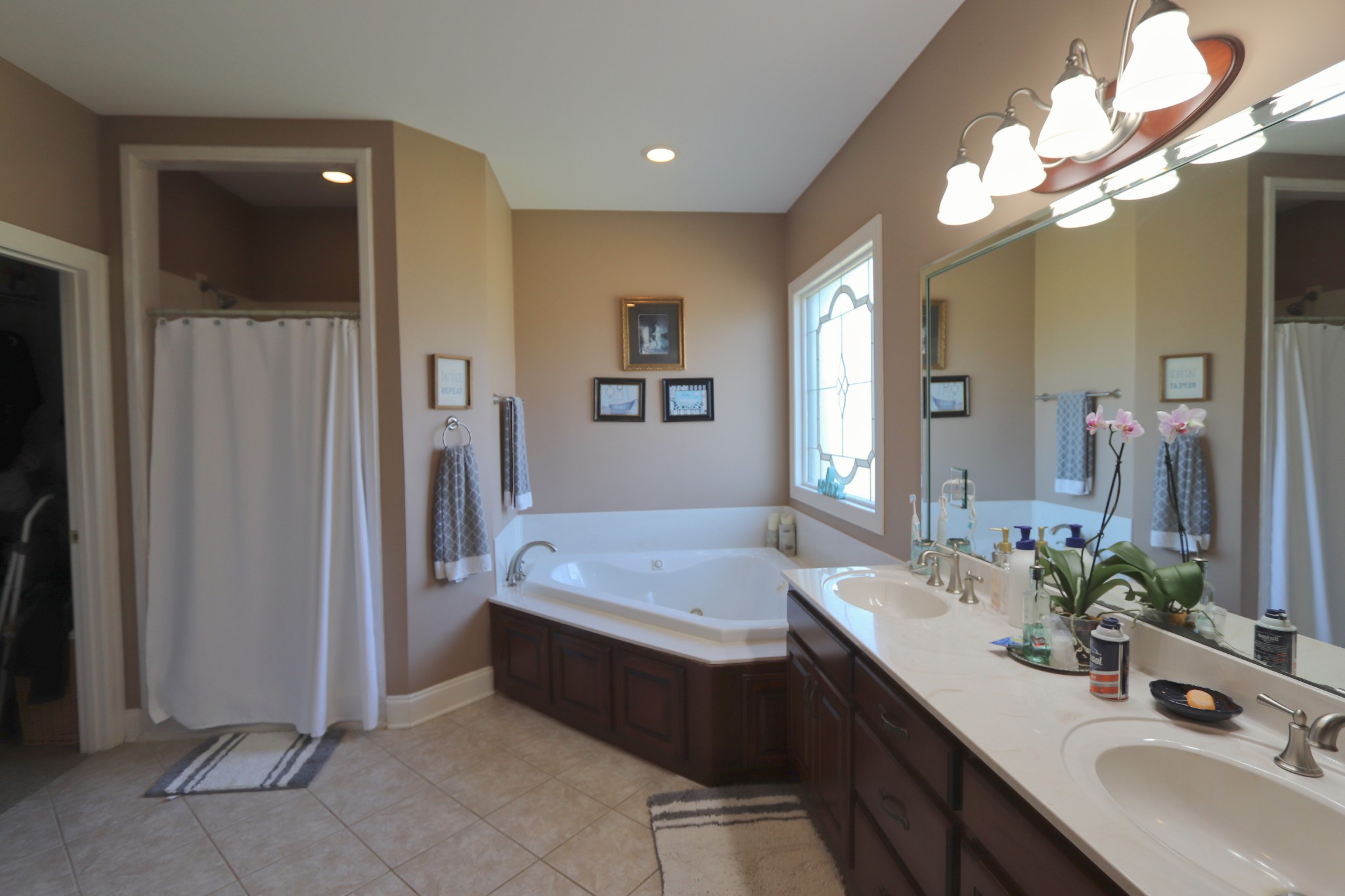 621 Hamilton Chambers Road Lebanon, TN 37087 - Photo 22 of 37 a spacious bathroom with a granite countertop sink a mirror and a shower