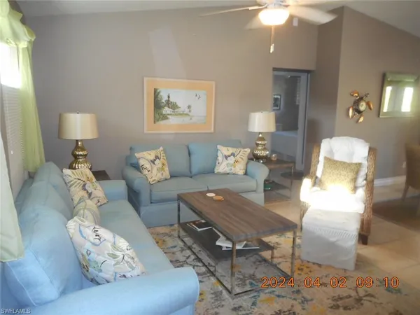 a living room with furniture and a lamp