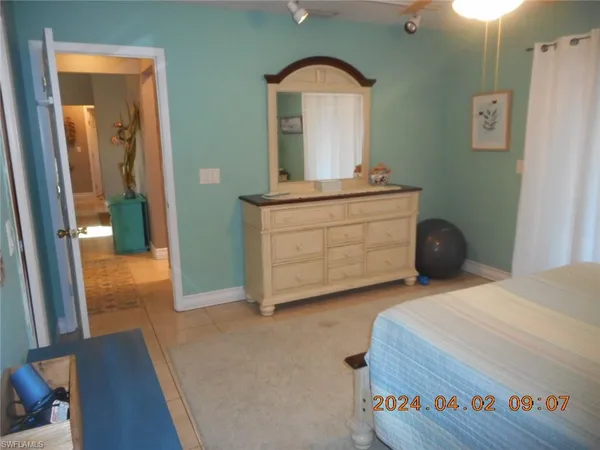 a bedroom with a bed and a dresser