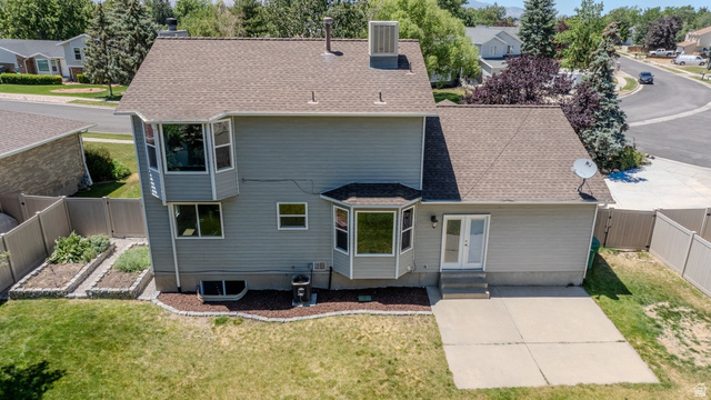11957 Noelle Road Sandy, UT 84092 - Photo 35 of 38 Rear exterior featuring light gray siding and a composition shingle roof