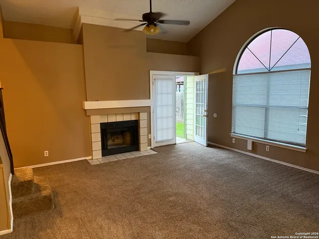a view of an empty room with a fireplace and a fireplace