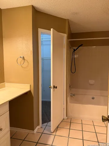 a bathroom with a shower and a sink