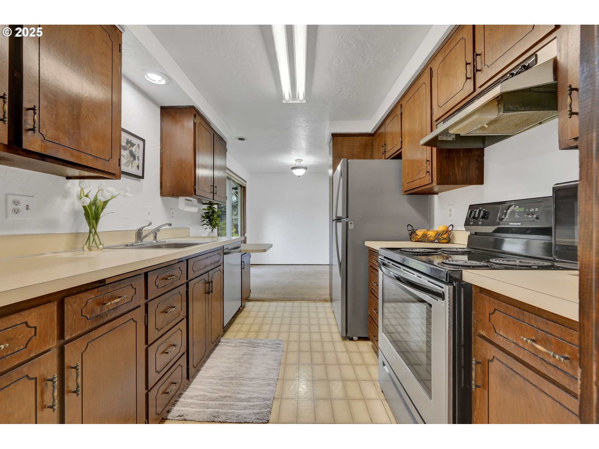 2480 Chuckanut Street Eugene, OR 97408 - Photo 16 of 44 a kitchen with stainless steel appliances granite countertop a sink stove and refrigerator