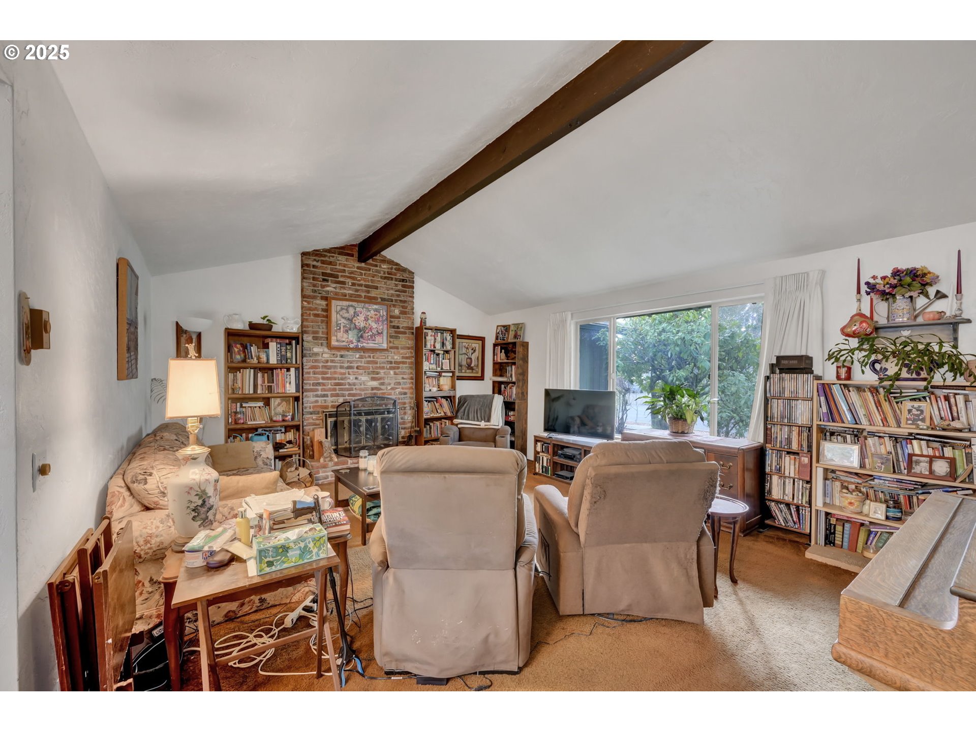 2480 Chuckanut Street Eugene, OR 97408 - Photo 28 of 44 a living room with furniture a flat screen tv and a floor to ceiling window
