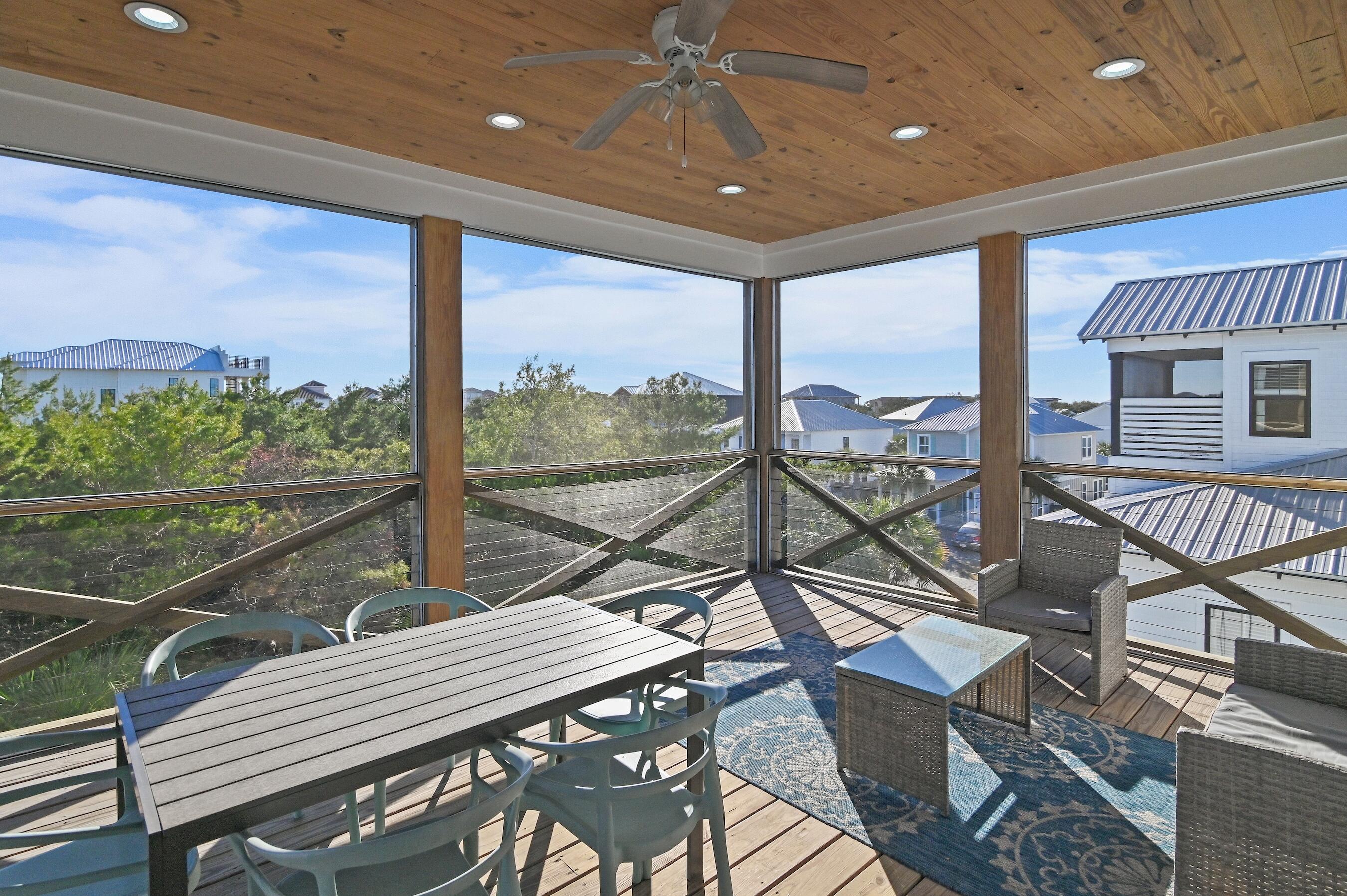 57 Penelope Street Miramar Beach, FL 32550 - Photo 14 of 62 a view of a balcony with chairs and wooden floor