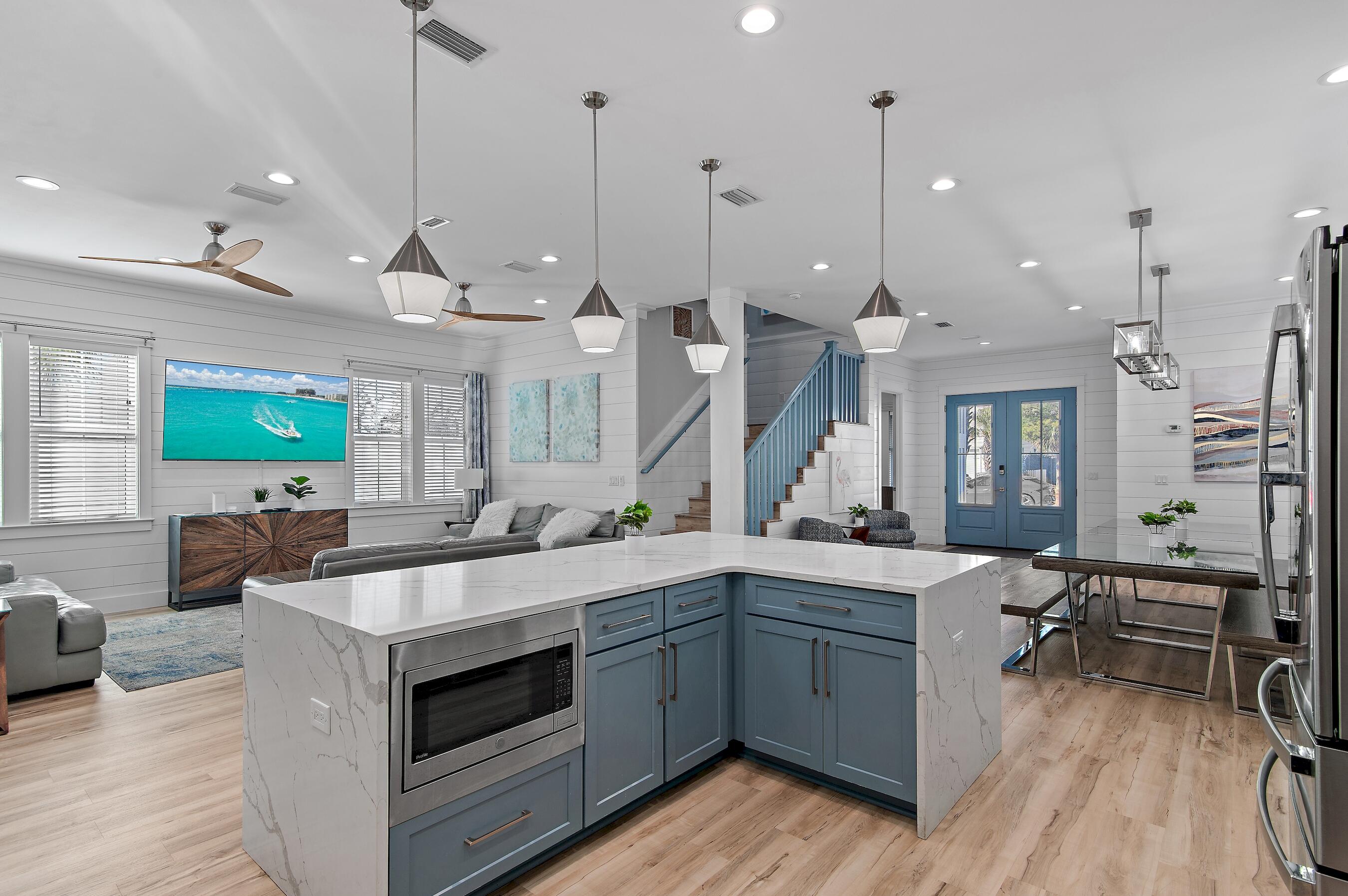 57 Penelope Street Miramar Beach, FL 32550 - Photo 22 of 62 a large kitchen with kitchen island a large island a sink a stove and a wooden floor