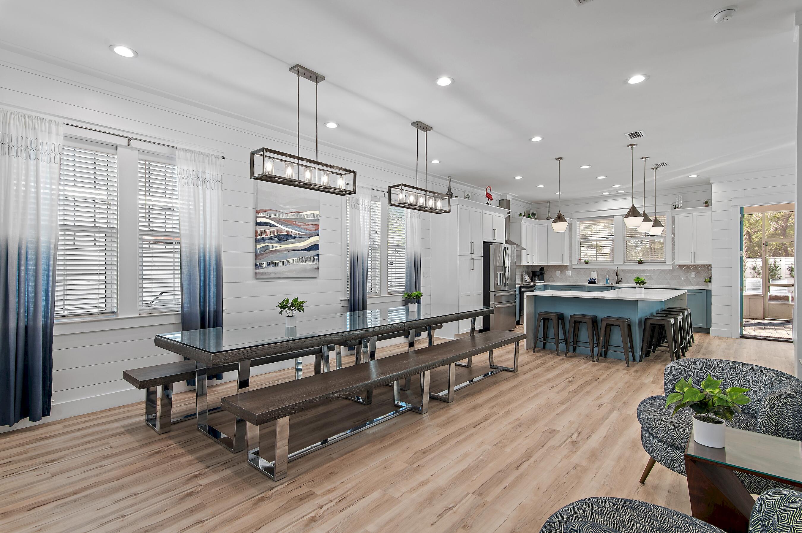 57 Penelope Street Miramar Beach, FL 32550 - Photo 26 of 62 a large room with kitchen island stainless steel appliances wooden floor dining table and chairs