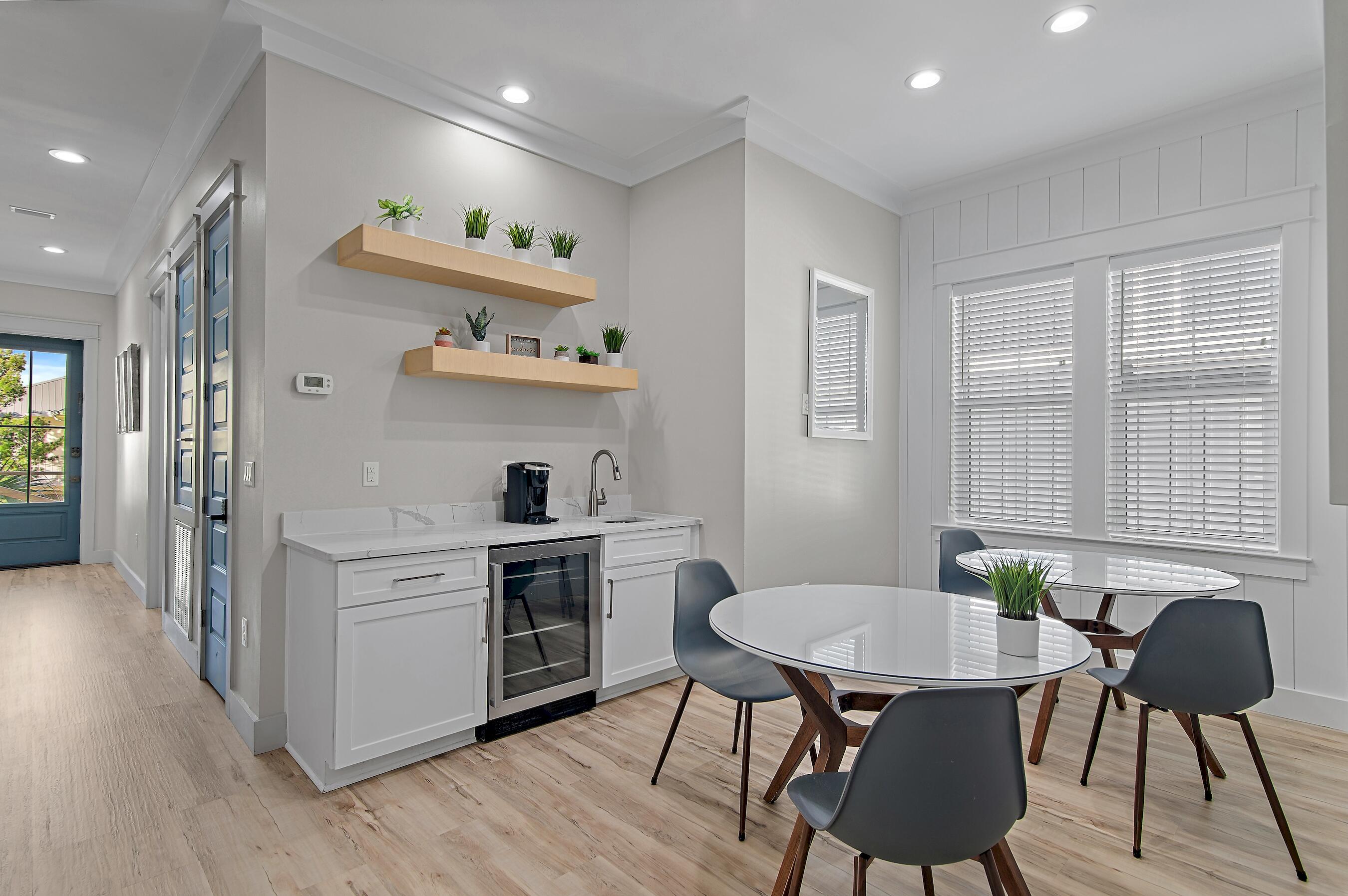 57 Penelope Street Miramar Beach, FL 32550 - Photo 33 of 62 a kitchen with stainless steel appliances a dining table chairs and a refrigerator