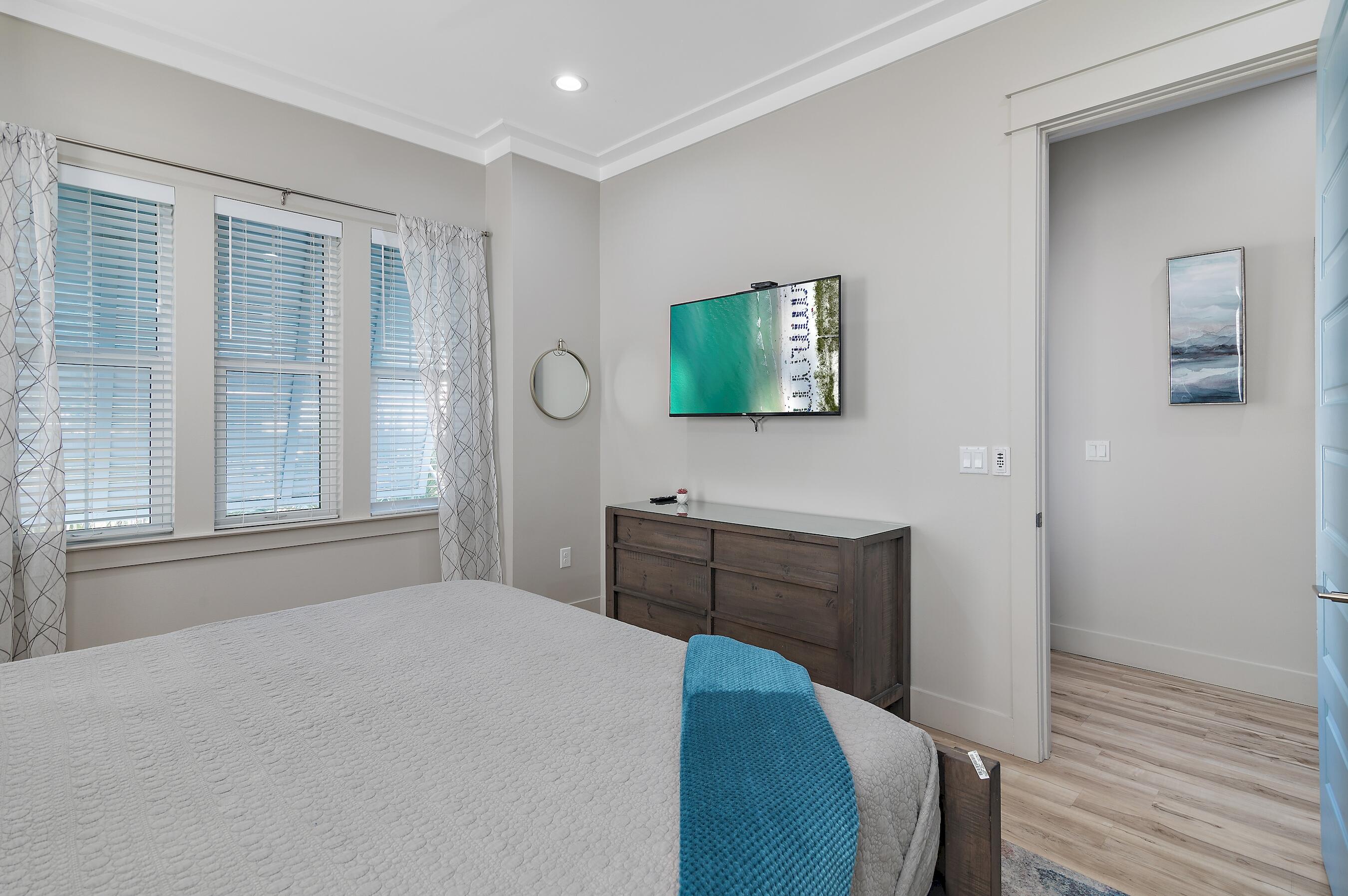 57 Penelope Street Miramar Beach, FL 32550 - Photo 50 of 62 a bedroom with a bed and wooden floor