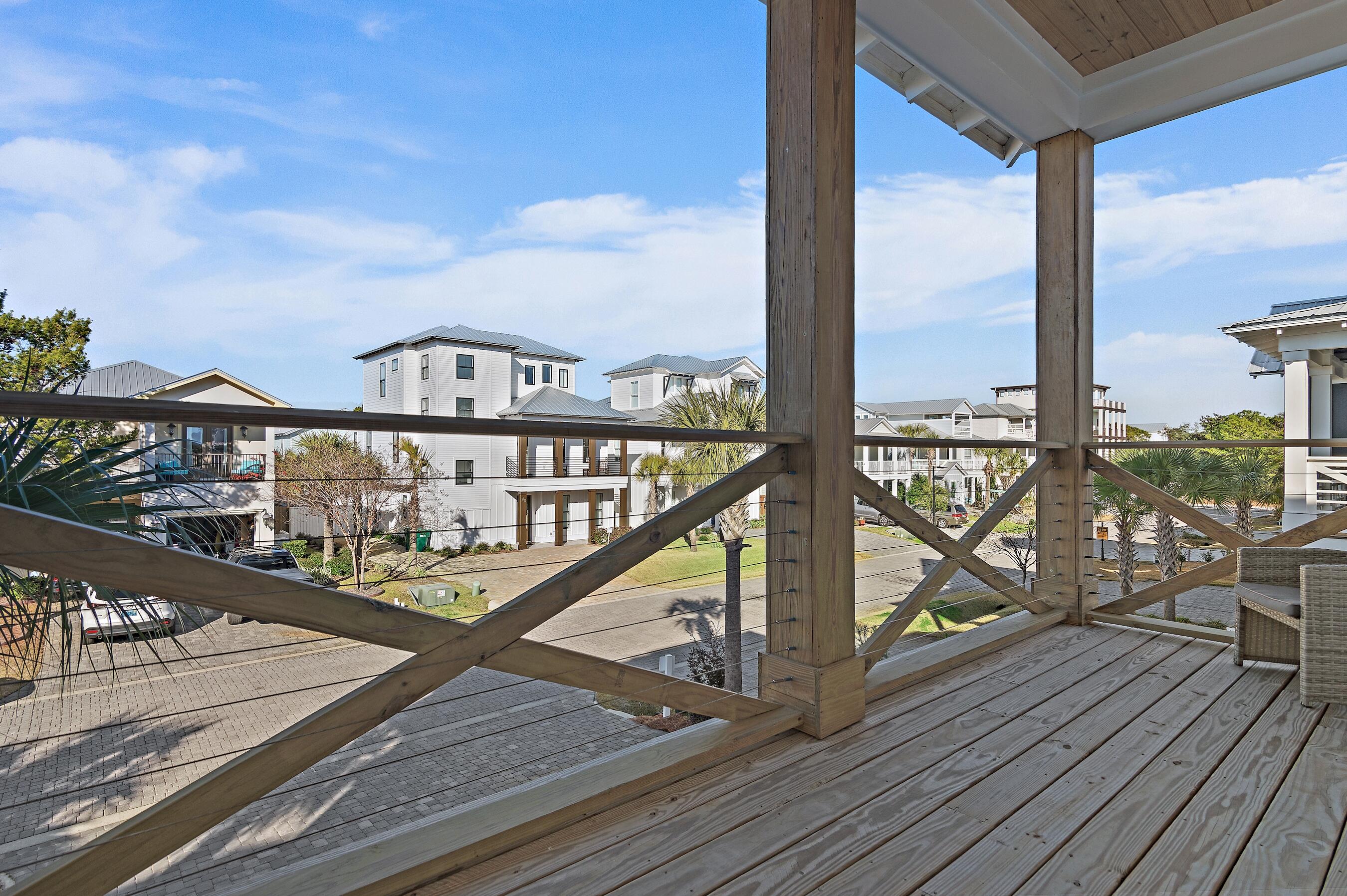57 Penelope Street Miramar Beach, FL 32550 - Photo 52 of 62 a view of a balcony with wooden floor next to a iron stairs
