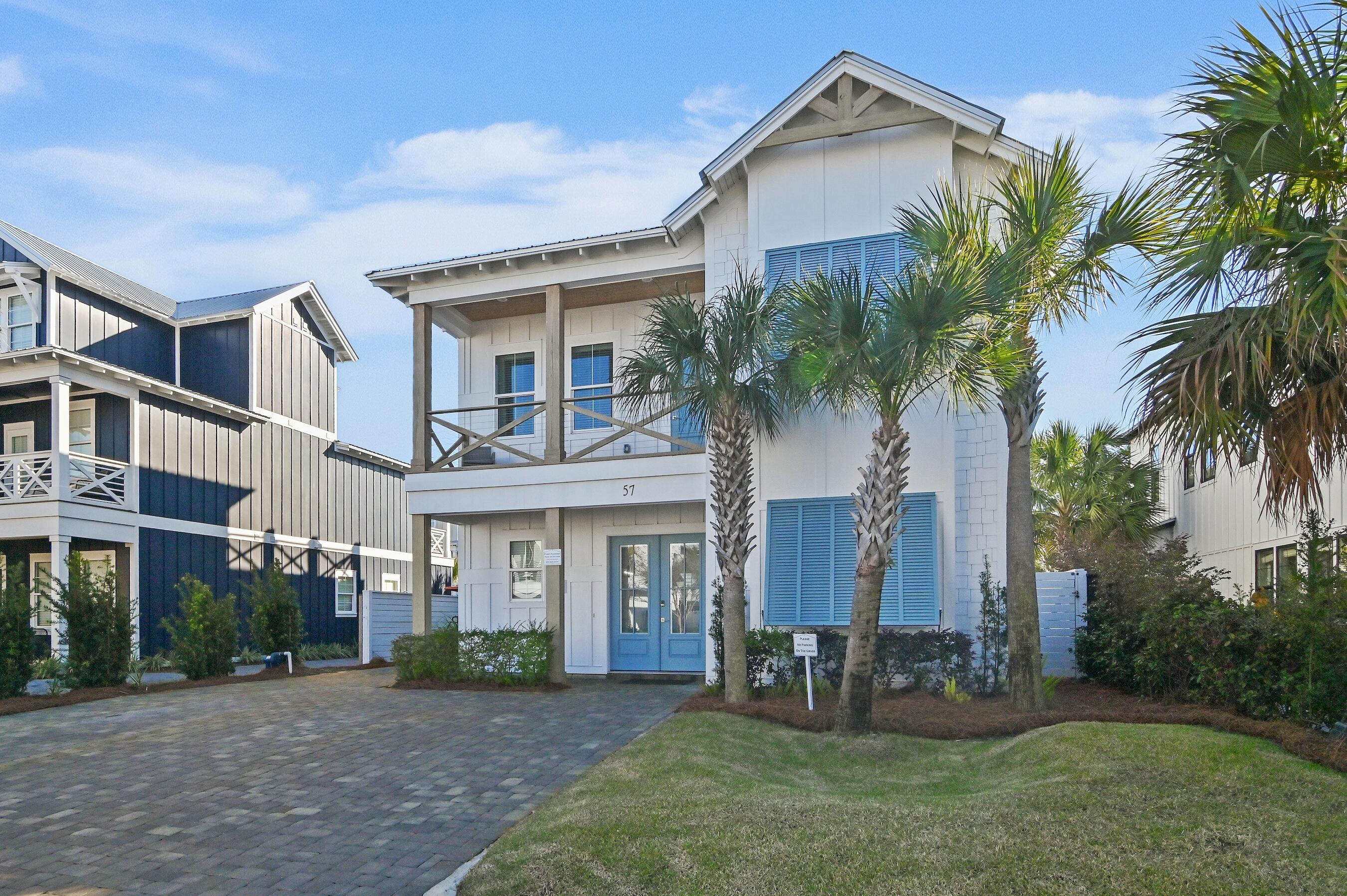57 Penelope Street Miramar Beach, FL 32550 - Photo 59 of 62 front view of a house with a yard and palm trees