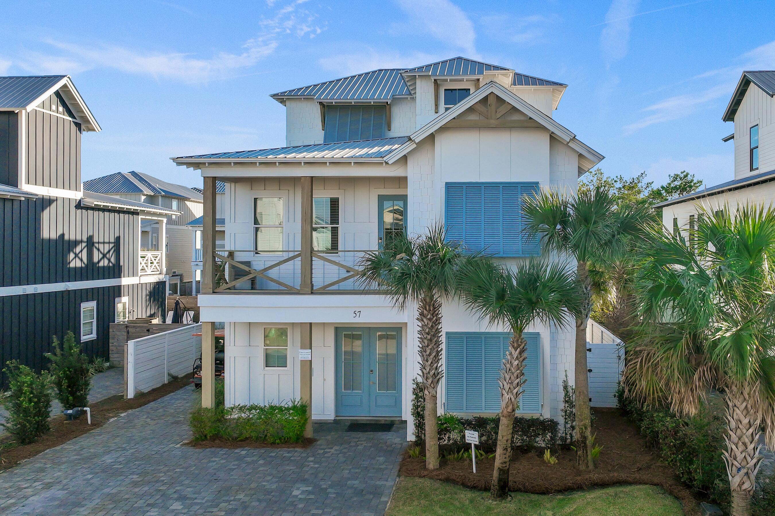 57 Penelope Street Miramar Beach, FL 32550 - Photo 60 of 62 a front view of a house with a yard garage and outdoor seating
