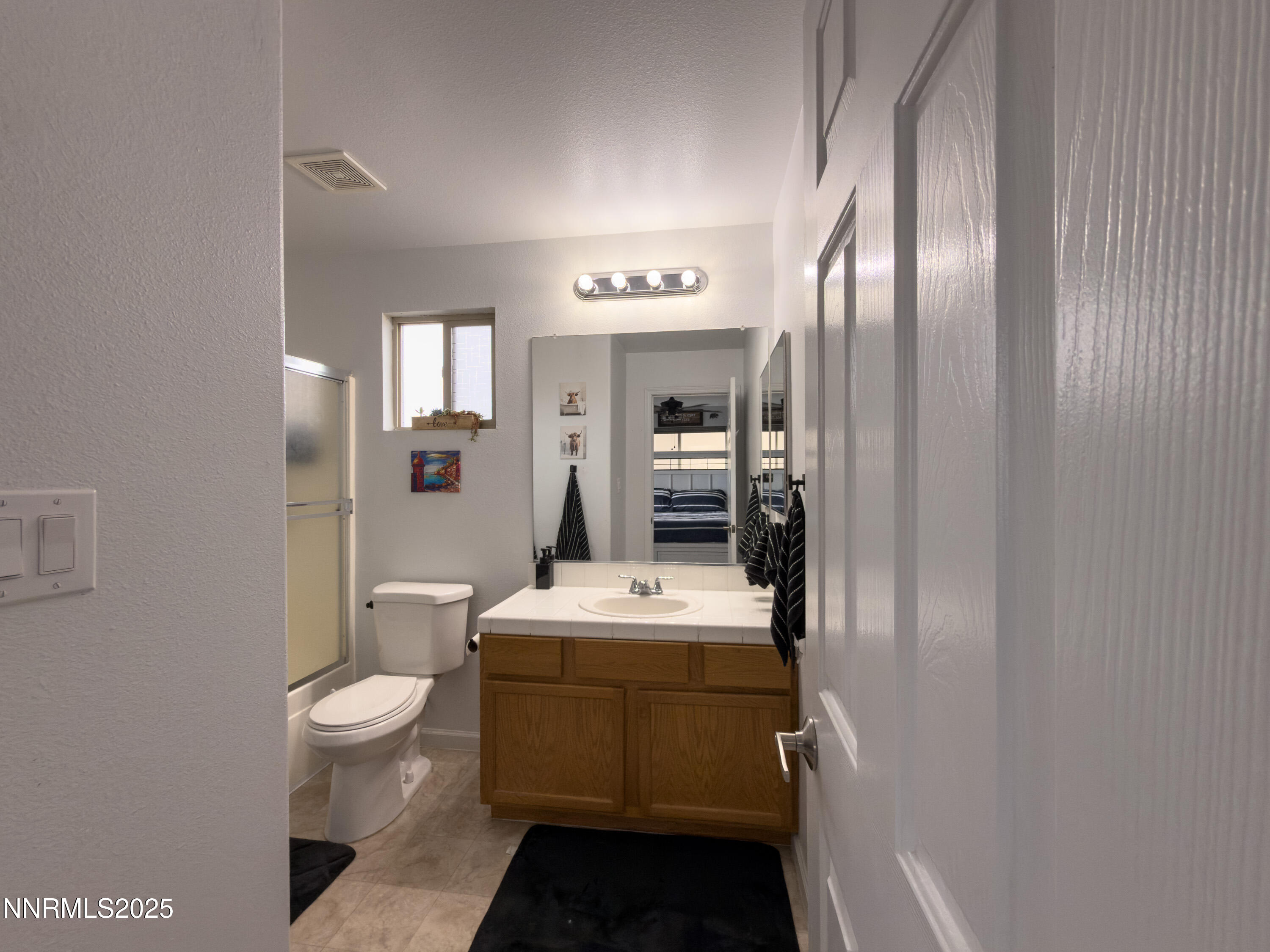 9635 Meadowstar Drive Reno, NV 89506 - Photo 20 of 26 a bathroom with a toilet a sink and mirror