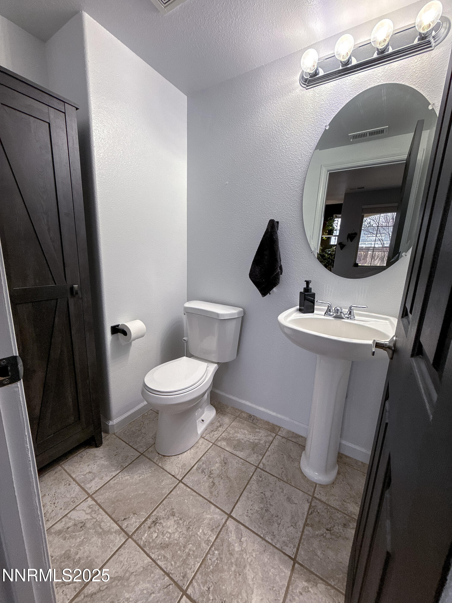 9635 Meadowstar Drive Reno, NV 89506 - Photo 7 of 26 a white toilet sitting next to a small sink