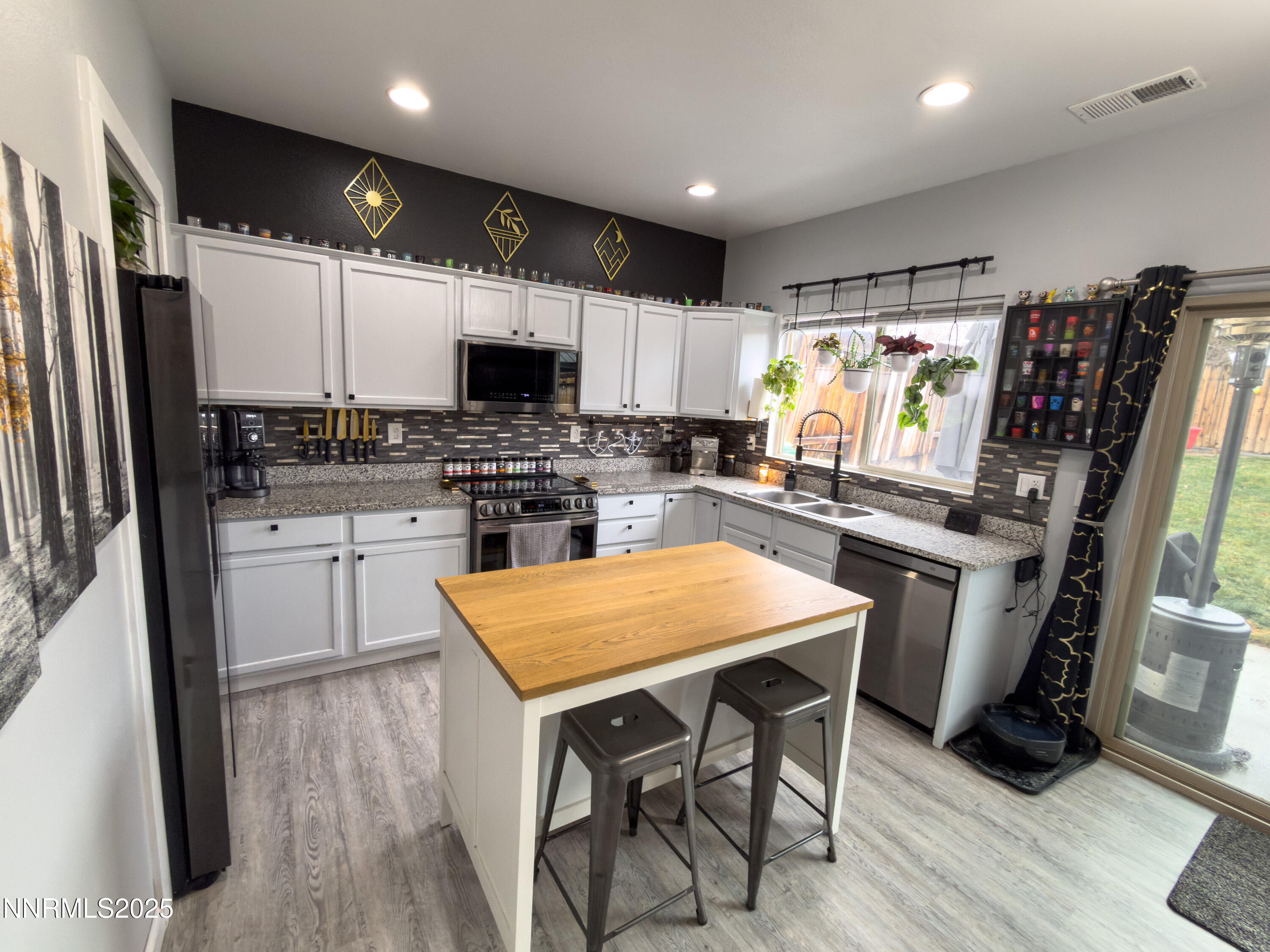 9635 Meadowstar Drive Reno, NV 89506 - Photo 10 of 26 a kitchen with stainless steel appliances a stove a sink dishwasher a refrigerator and a oven with wooden floor