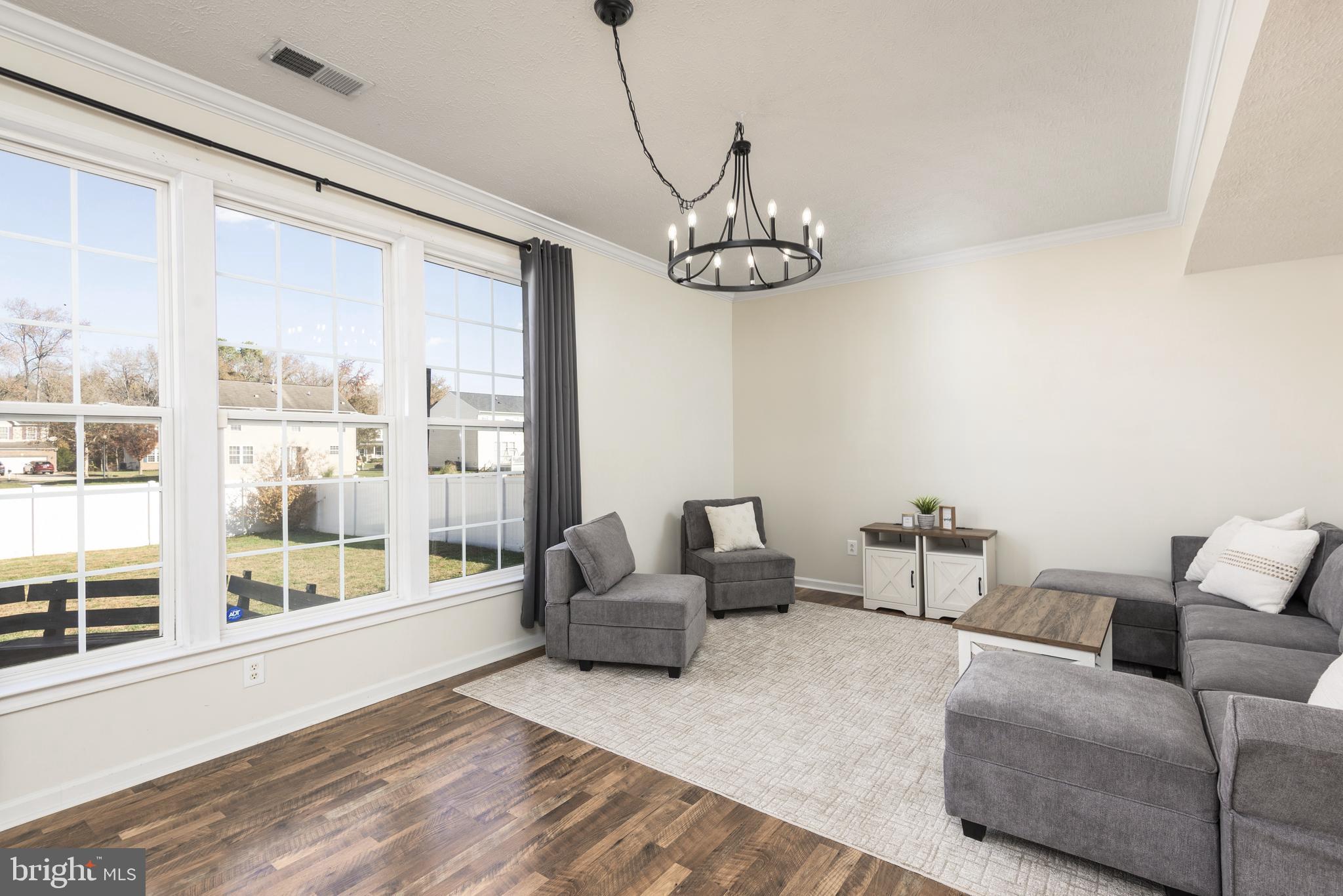 1208 Painted Fern Road Denton, MD 21629 - Photo 12 of 39 a living room with furniture or outdoor view and a large window