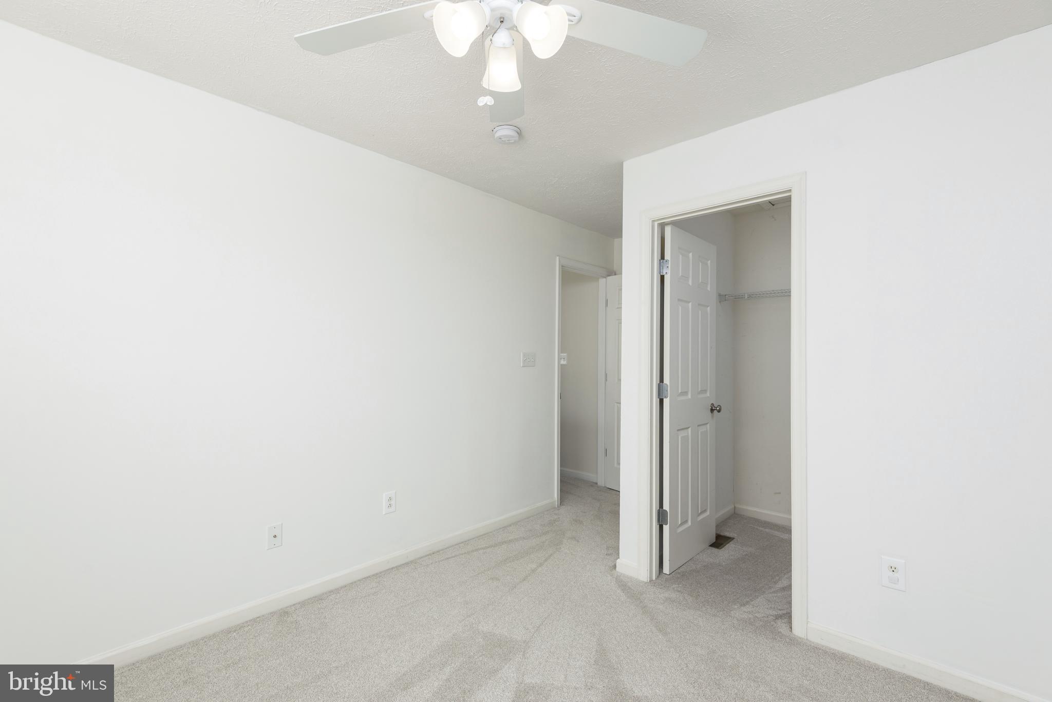 1208 Painted Fern Road Denton, MD 21629 - Photo 20 of 39 an empty room with a ceiling fan and bathroom