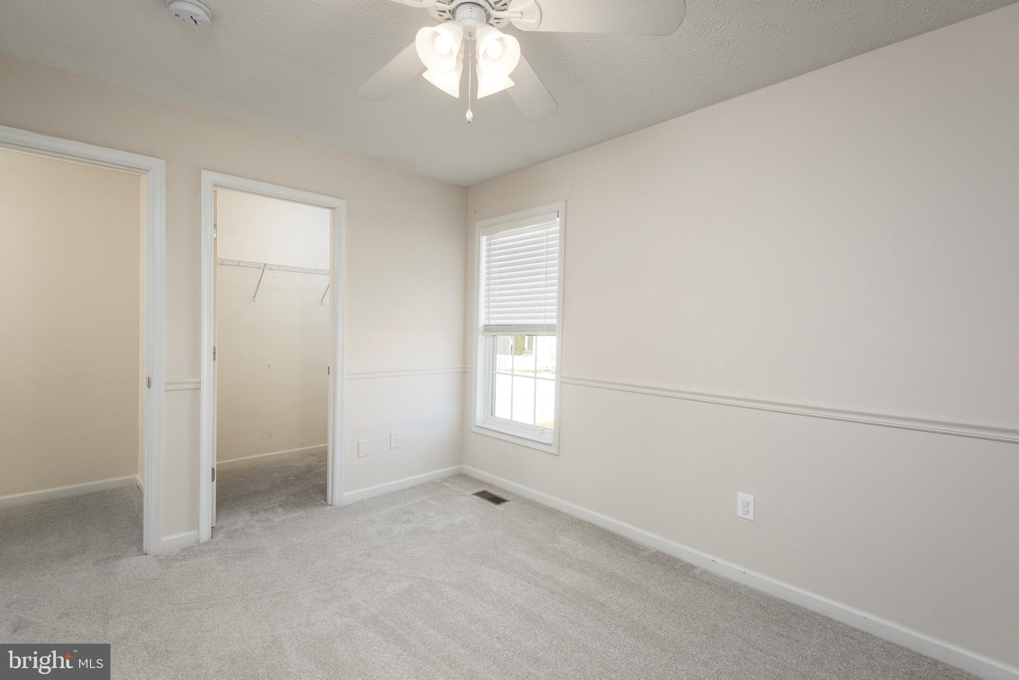 1208 Painted Fern Road Denton, MD 21629 - Photo 21 of 39 wooden floor in an empty room with a window