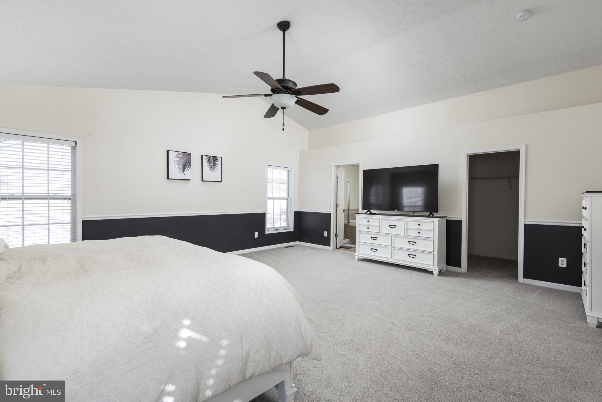1208 Painted Fern Road Denton, MD 21629 - Photo 29 of 39 a bedroom with a bed and a flat screen tv