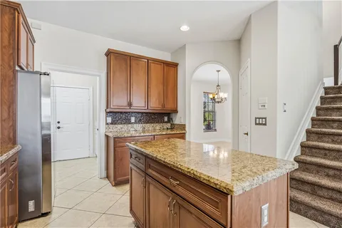 a bedroom with a bed lamp and a potted plant