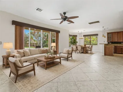 a kitchen with stainless steel appliances granite countertop a stove top oven a sink dishwasher and a refrigerator with wooden cabinets