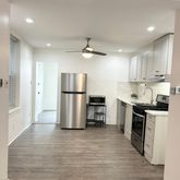 a kitchen with stainless steel appliances granite countertop a refrigerator a stove a sink and a refrigerator