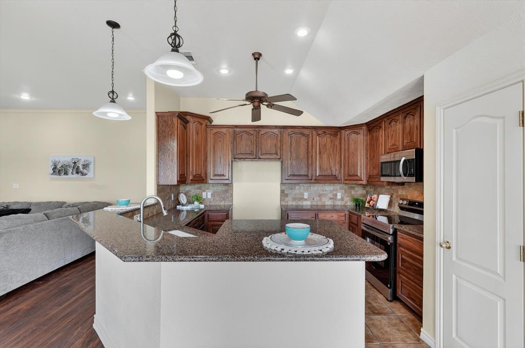 2828 Bennett Road Howe, TX 75459 - Photo 12 of 39 a kitchen with sink refrigerator and microwave