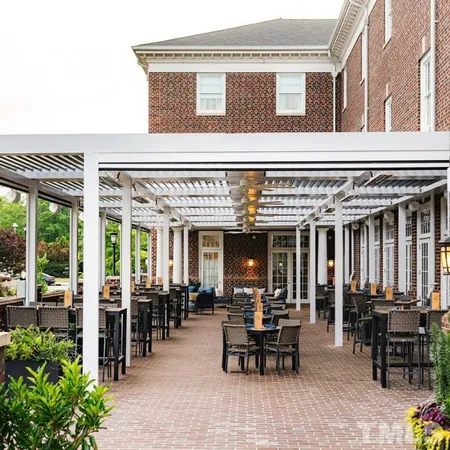 a room with wooden floor and potted plant