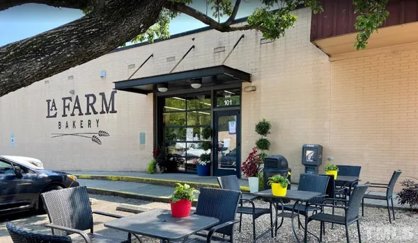 a view of a patio with a table and chairs under an umbrella