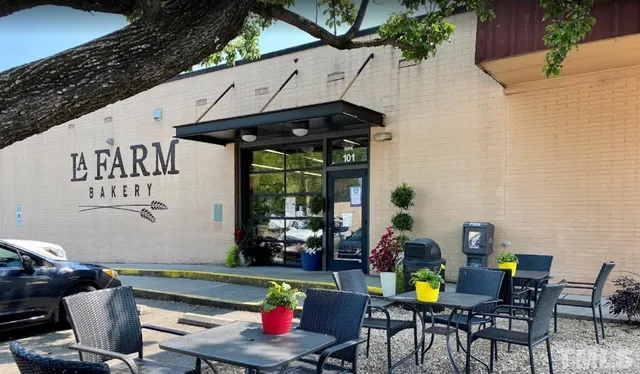 a view of a patio with a table and chairs under an umbrella