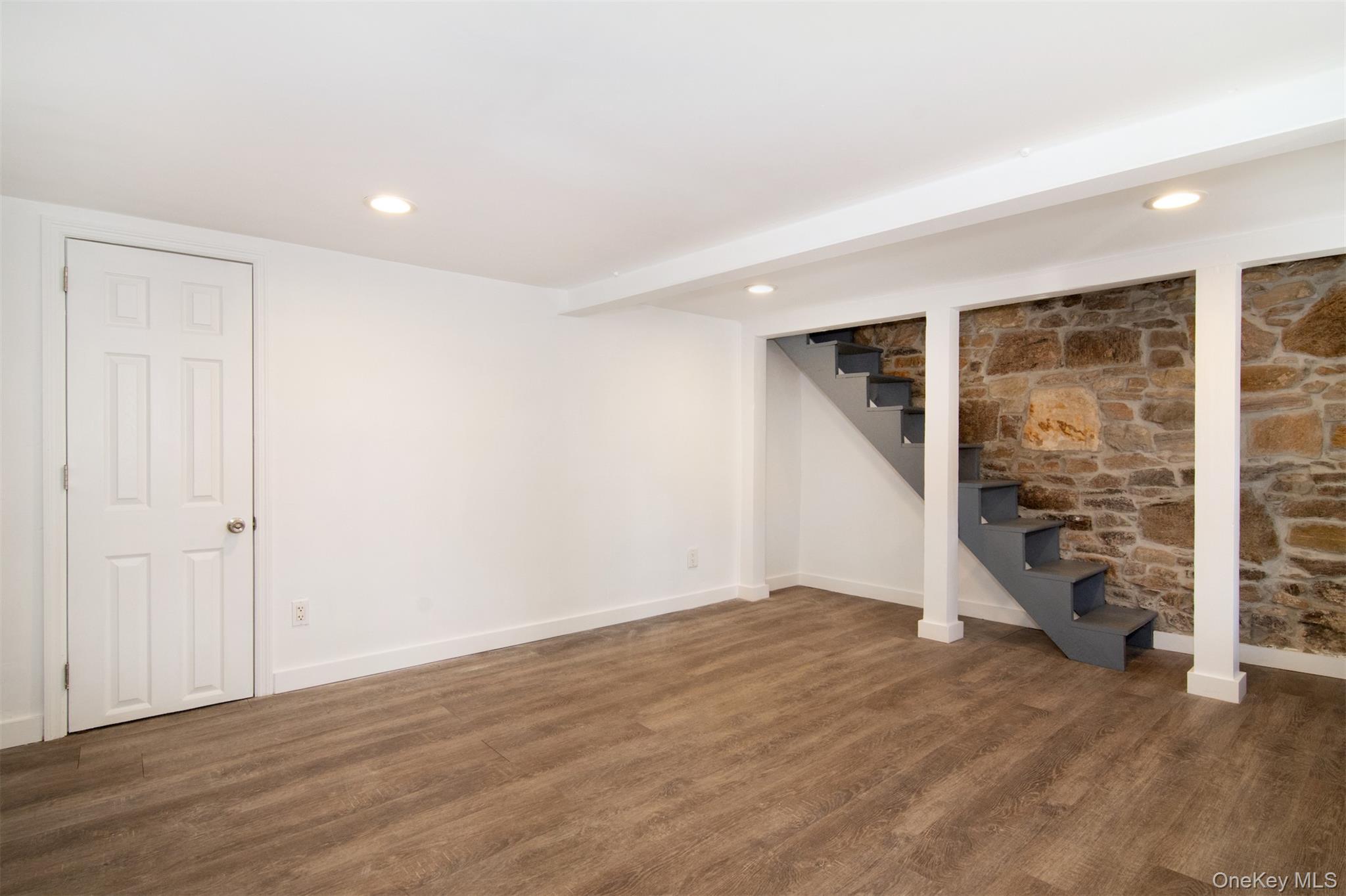 44 Ridge Street, Unit 1 Hastings-on-Hudson, NY 10706 - Photo 12 of 16 Walkout Lower level featuring baseboard heating and dark hardwood / wood-style floors