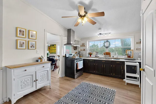 a kitchen with stainless steel appliances kitchen island granite countertop a sink and cabinets