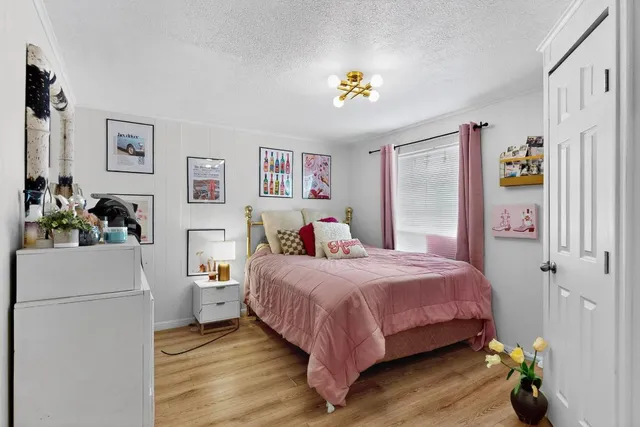 a bedroom with a bed and a chandelier