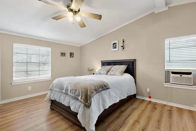 a bedroom with a bed and a window