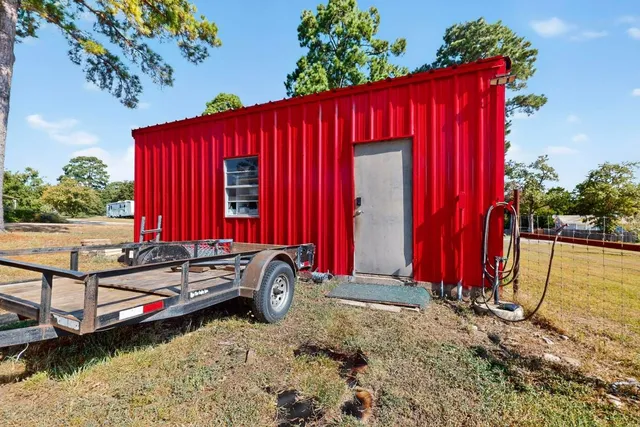 a view of a house with swimming pool and wooden fence