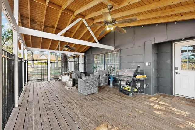 a view of a patio with table and chairs and wooden floor