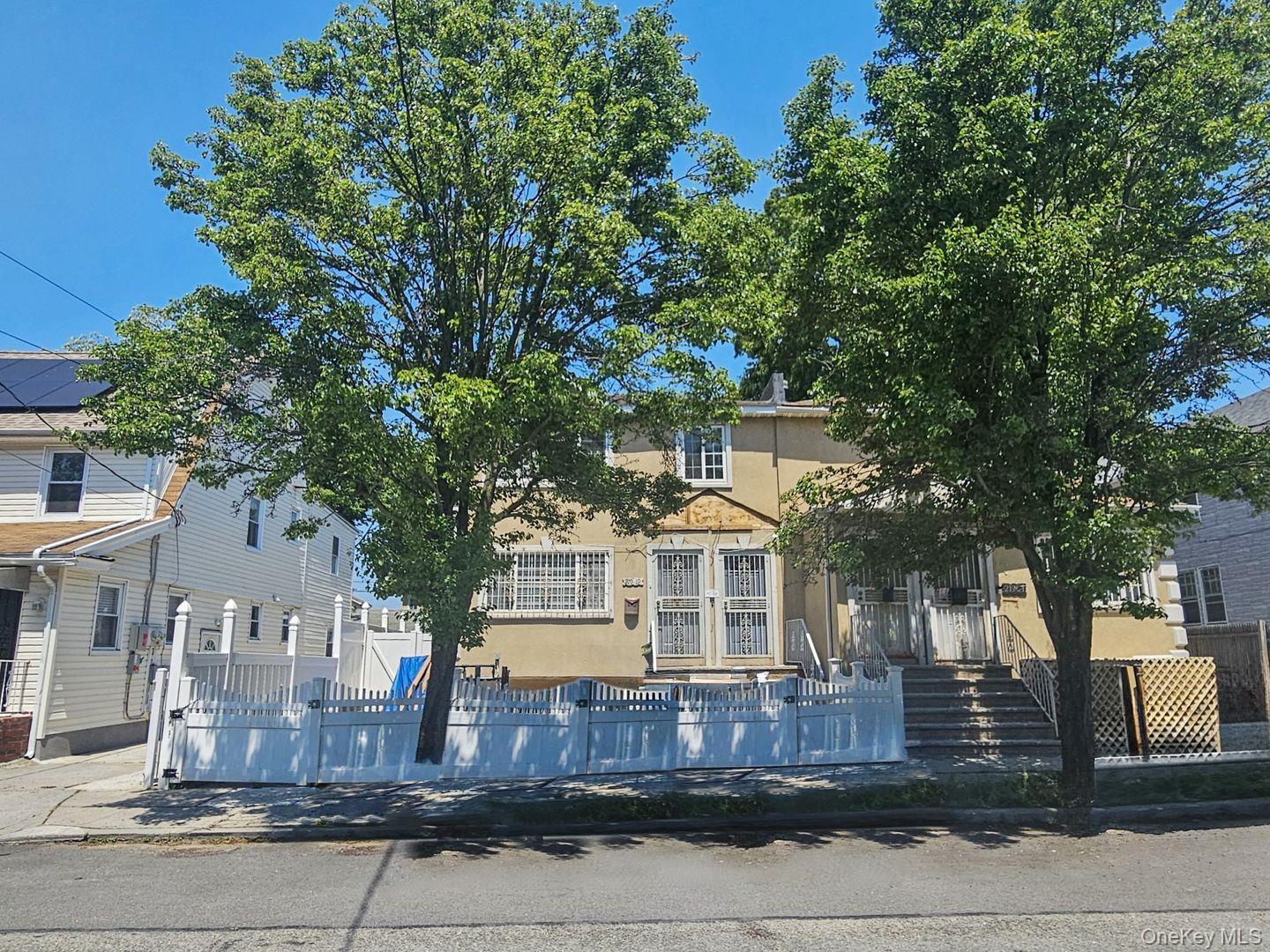 219-19 143rd Road Queens, NY 11413 - Photo 4 of 4 a front view of a house with a garden