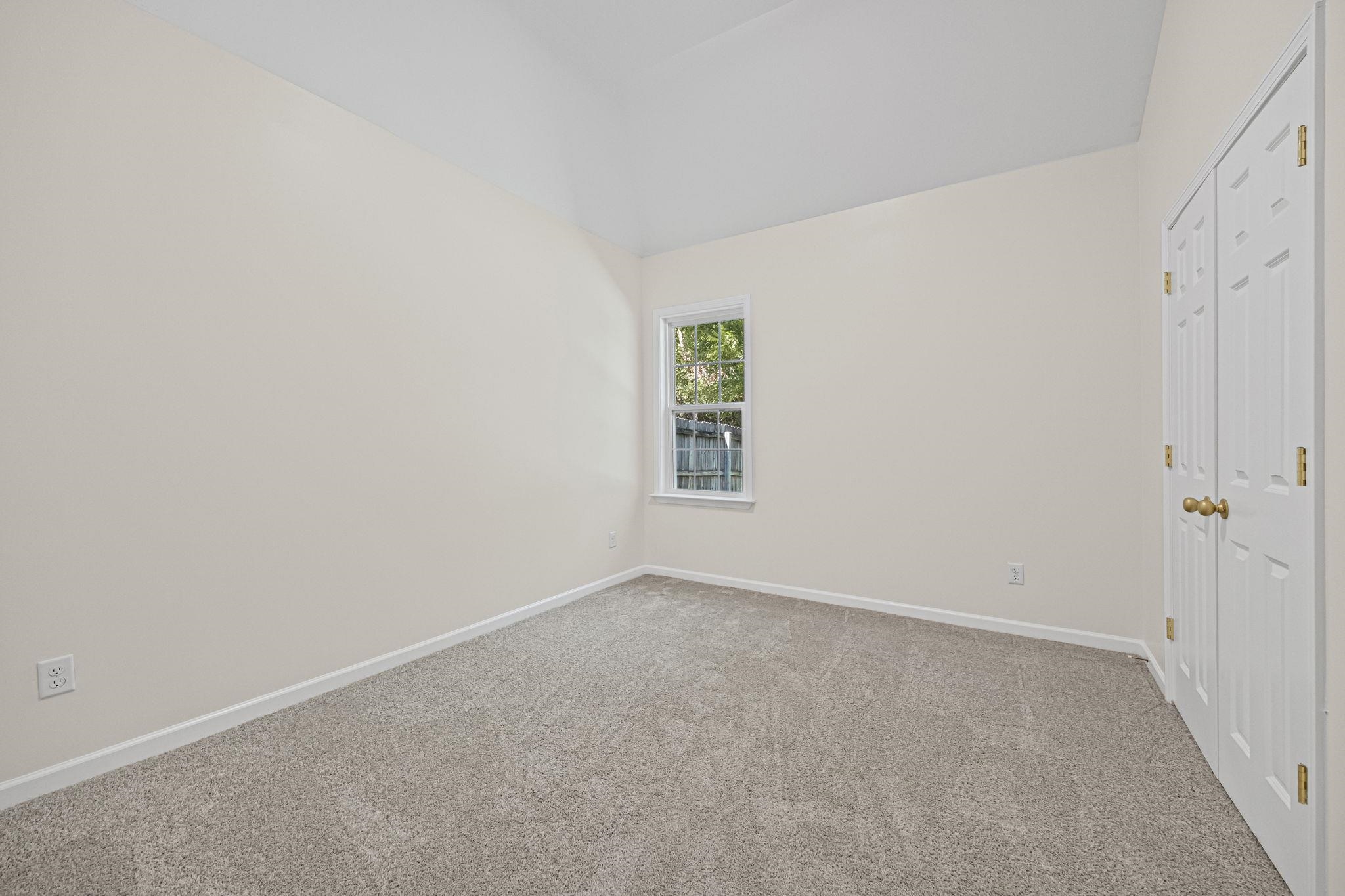 8670 Valmont Circle Memphis, TN 38016 - Photo 18 of 33 Unfurnished bedroom with carpet, a closet, and vaulted ceiling