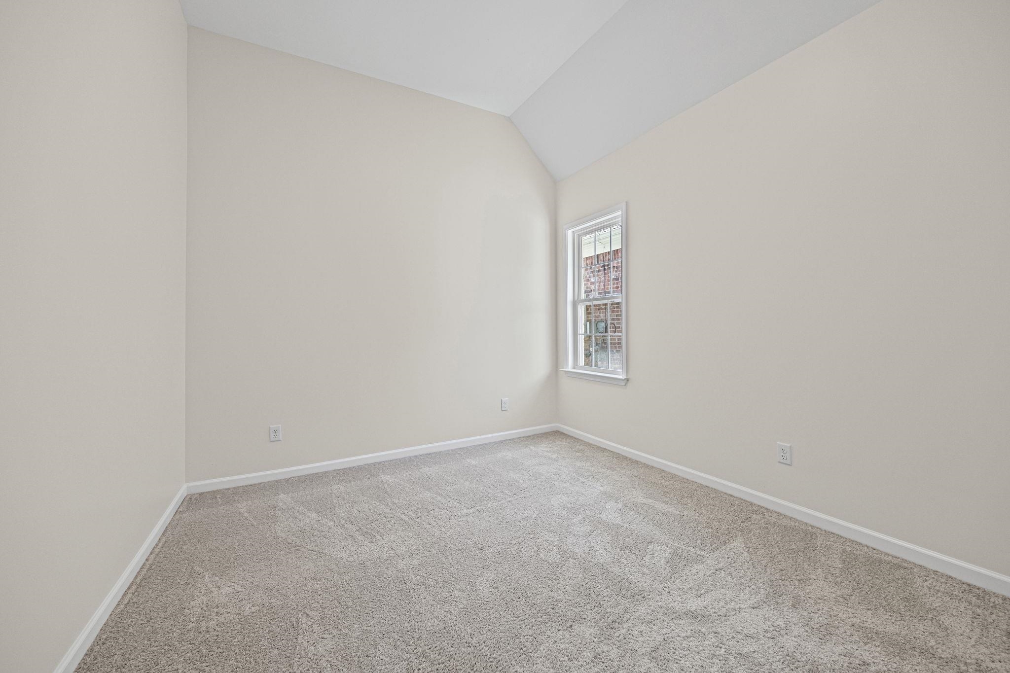 8670 Valmont Circle Memphis, TN 38016 - Photo 21 of 33 Empty room featuring lofted ceiling and carpet