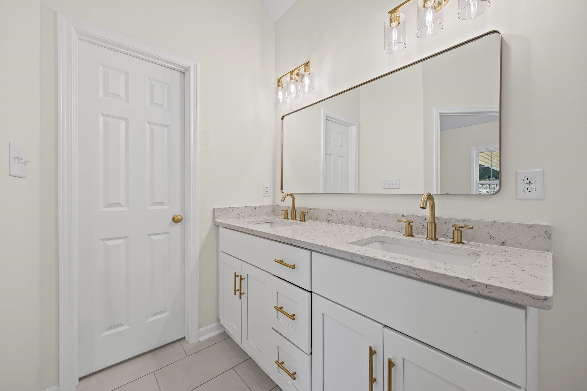 8670 Valmont Circle Memphis, TN 38016 - Photo 27 of 33 Full bathroom featuring double vanity and light tile patterned flooring