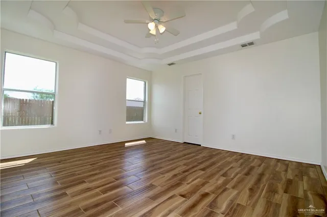 wooden floor in an empty room with a window