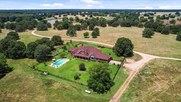 a view of a swimming pool with a yard