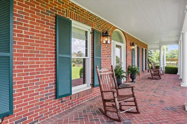 a view of a patio with a table and chairs and potted plants