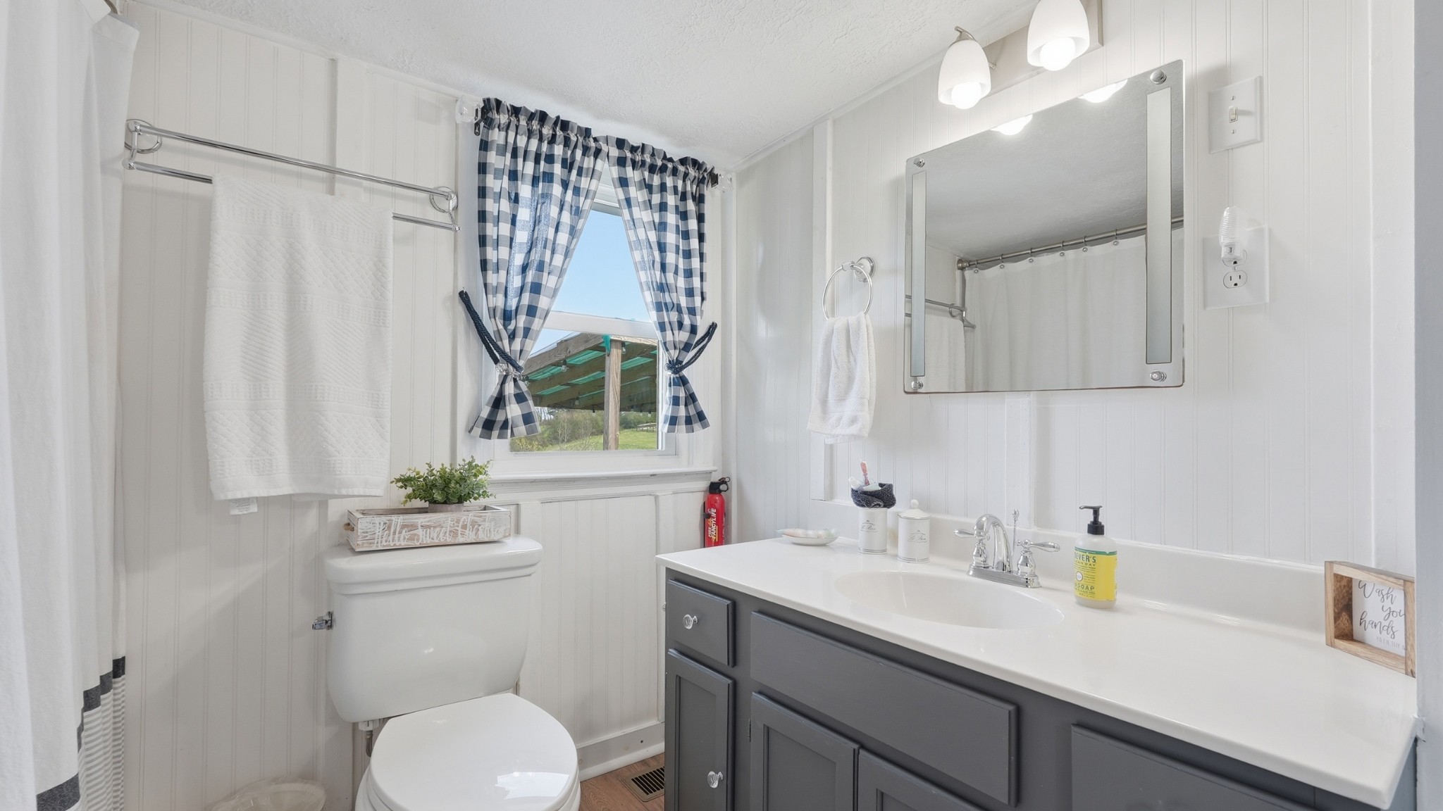 2820 Lockertsville Road Ashland City, TN 37015 - Photo 35 of 47 a bathroom with a sink a toilet and a mirror