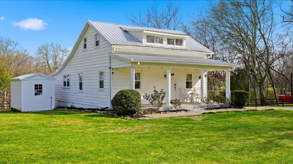 a front view of a house with garden and porch