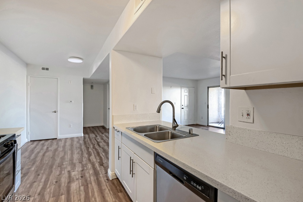 7885 West Flamingo Road, Unit 1003 Las Vegas, NV 89147 - Photo 13 of 22 Gleaming stone countertops and modern cabinetry highlight this highly functional kitchen workspace.