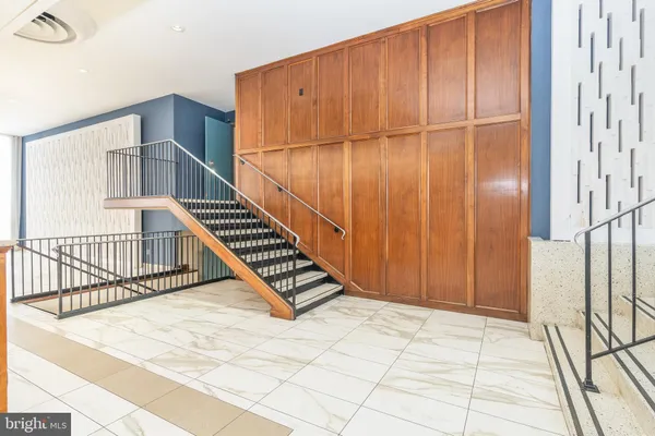 a view of a livingroom with wooden floor and staircase