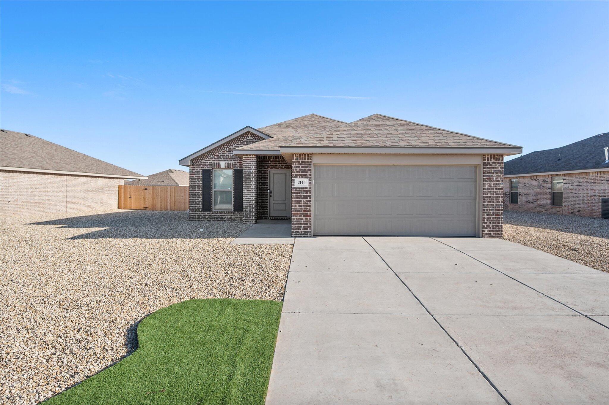 2130 Langford Avenue Lubbock, TX 79407 - Photo 1 of 1 a front view of a house with a yard and garage